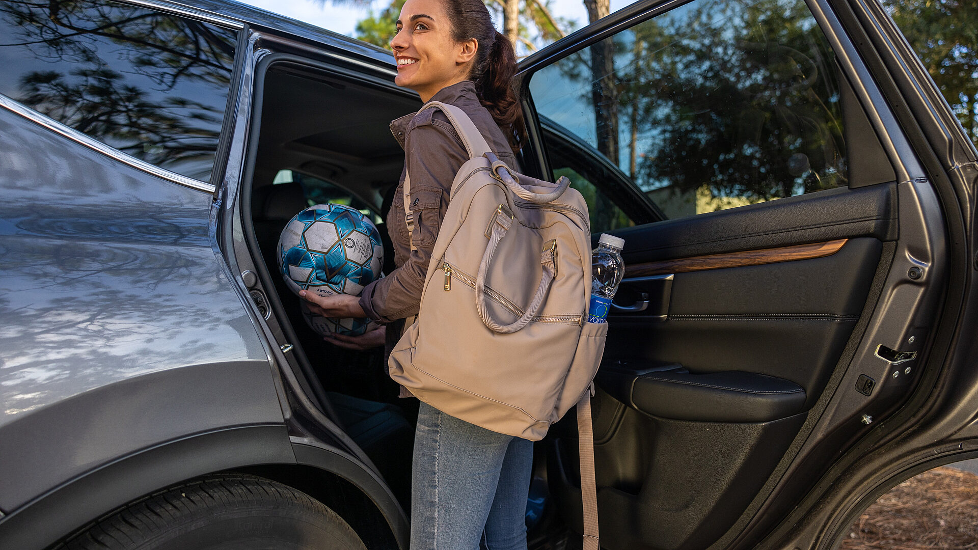Soccer mom loading car with equipment